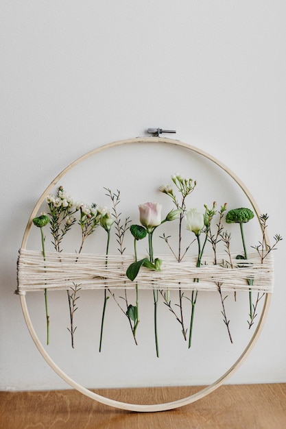 Three embroidery hoops with floral patterns