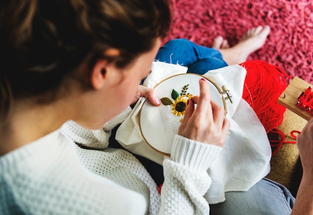 Hands holding finished embroidered pieces